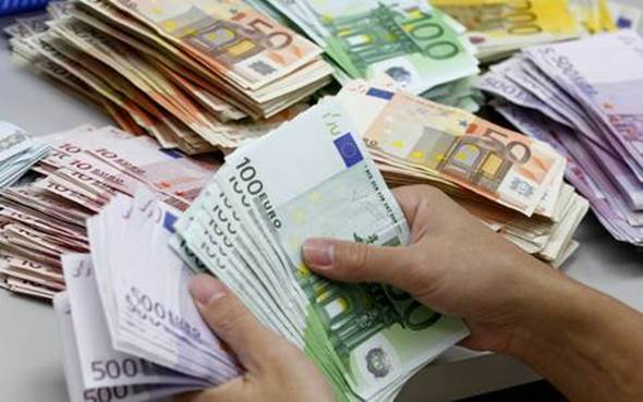 A bank employee counts Euro notes at Kasikornbank in Bangkok